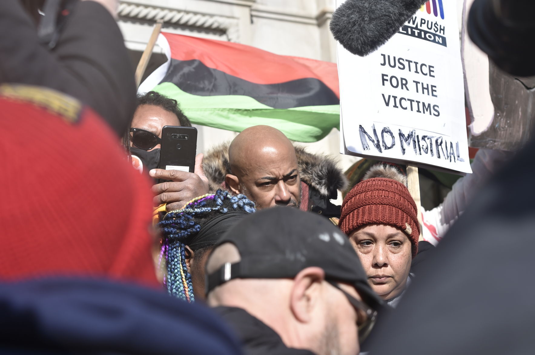 At right, Justin Blake, Bishop Tavis Grant and Tanya McLean listen to Rittenhouse verdicts